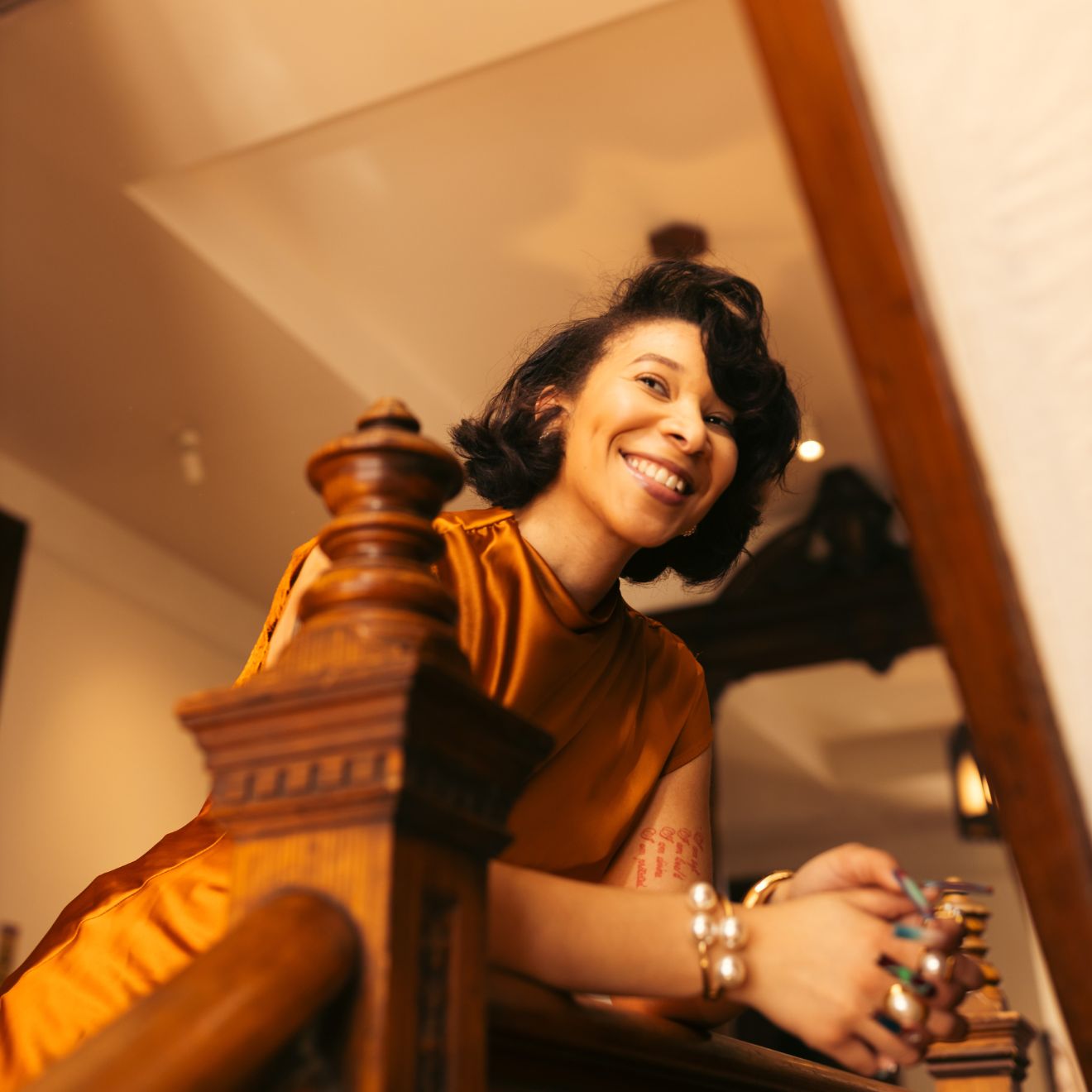 Shannon Johnson in a yellow dress sitting at a table with a warm, indoor setting. | B. Marie Accessories, Shannon Johnson, DMV