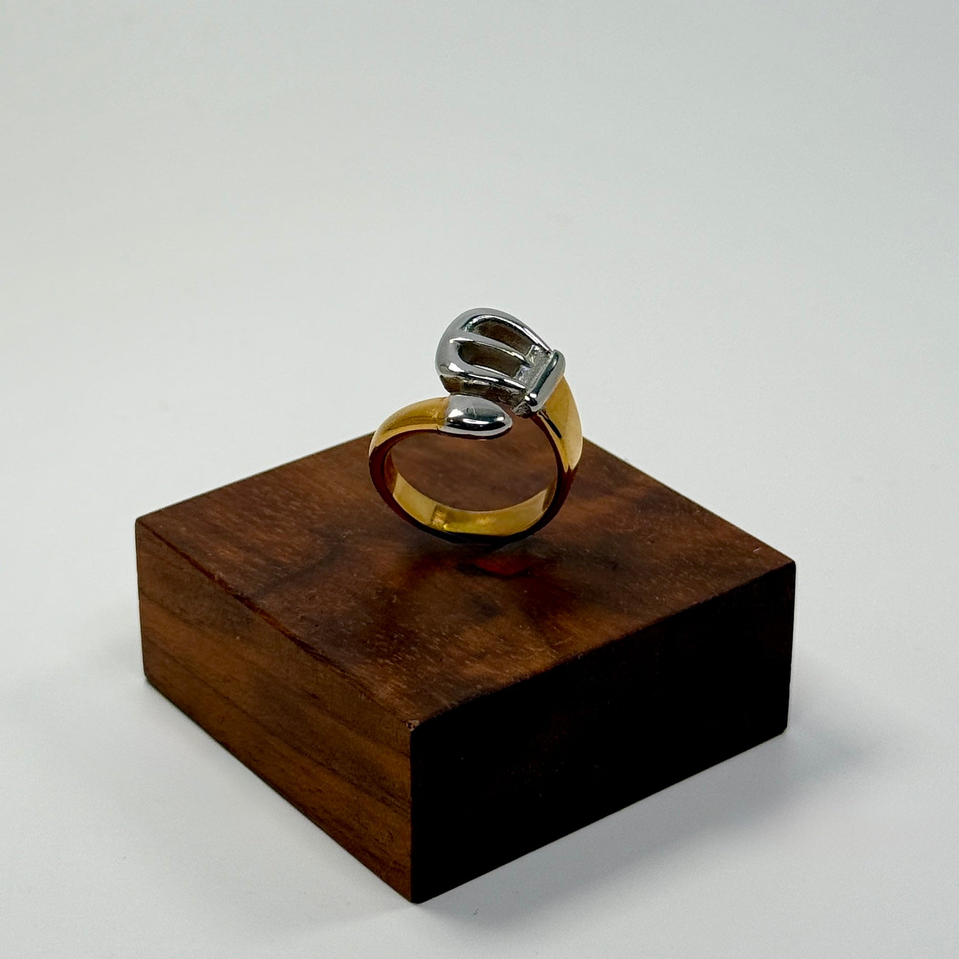 Gold and silver ring on a wooden stand against a white background | B. Marie Accessories, Shannon Johnson, DMV