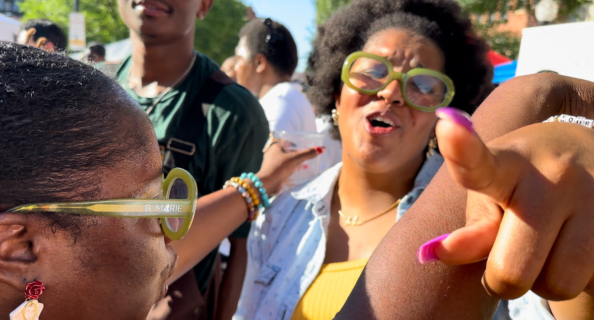Two women wearing novelty sunglasses in a crowd | B. Marie Accessories, Shannon Johnson, DMV