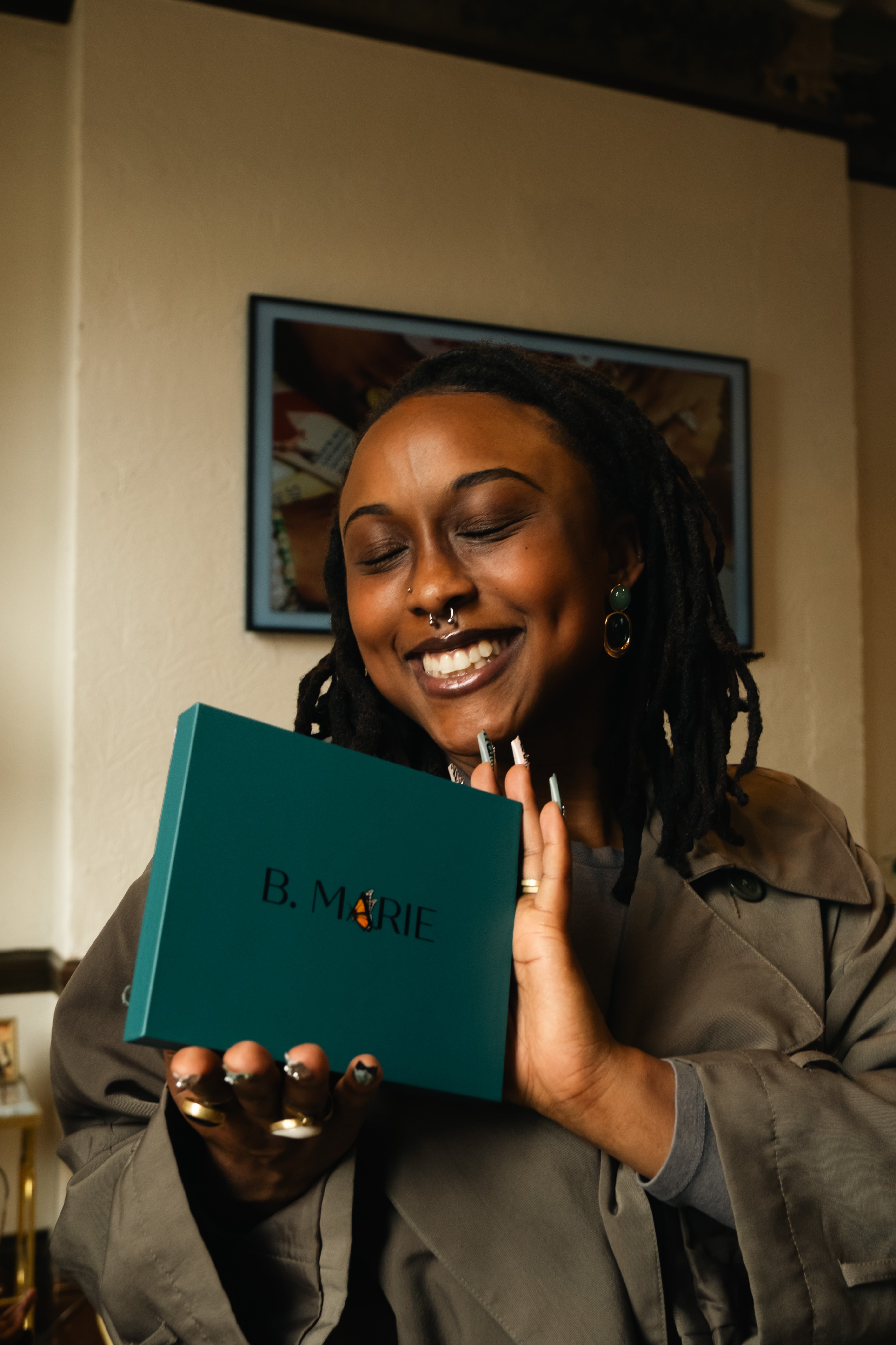 Person holding a teal book titled 'B. Marie' with a blurred background | B. Marie Accessories, Shannon Johnson, DMV